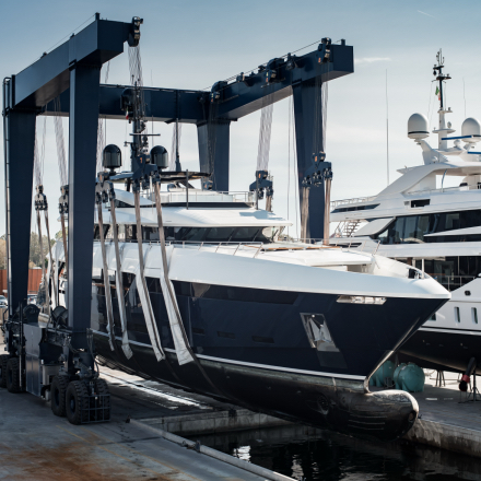 Super,Yacht,Hauled,Out,In,Shipyard,,Being,Lifted,By,Industrial